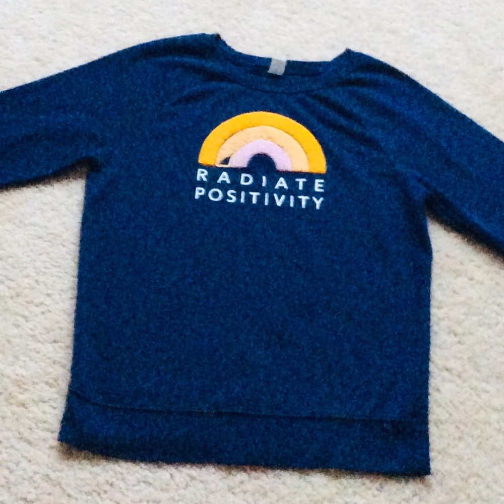 blue sweatshirt with a quote on the front